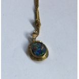An opal mounted pendant on fine link chain. Approx