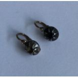 A pair of Antique diamond ear studs in rubover mou