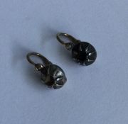 A pair of Antique diamond ear studs in rubover mou