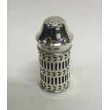 An Edwardian silver pepper with pierced decoration