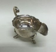 A rare George II silver cream boat with crested ar