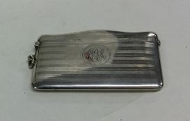 A large engine turned silver card case with hinged