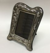 A large modern silver picture frame decorated with