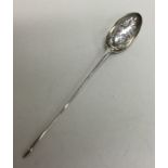 A large silver and rat tail mote spoon with scroll