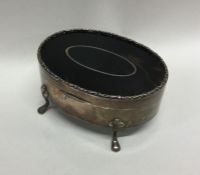 A silver and tortoiseshell ring box of oval form.