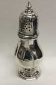 A large Edwardian silver sugar caster with lift-of