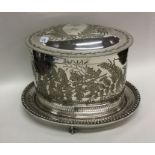 An attractive oval engraved biscuit barrel on ball