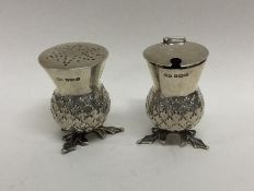 An unusual two piece silver cruet in the form of a