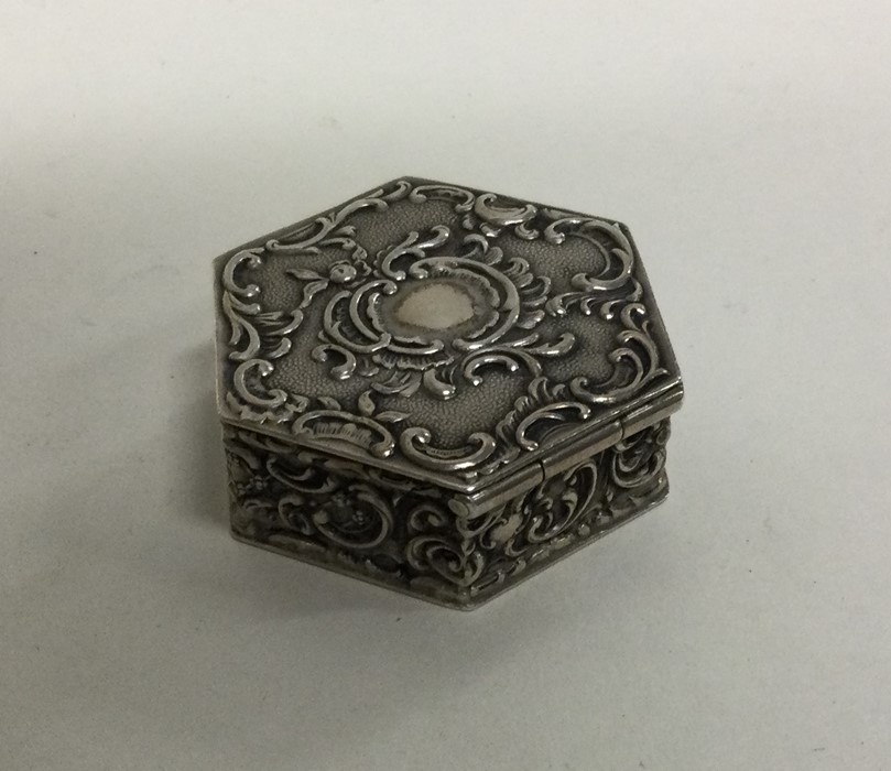 A heavy cast silver hinged top box with gilt inter