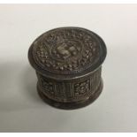 An Eastern silver cylindrical box decorated with a