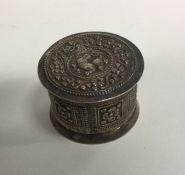 An Eastern silver cylindrical box decorated with a