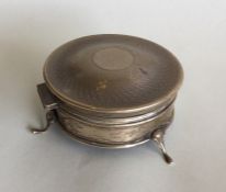 A silver ring box on three spreading feet. Birming