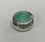 A silver and enamelled circular pill box with hing