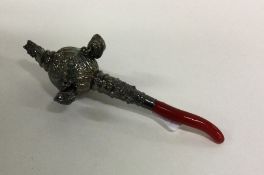 A silver rattle together with matching teether emb
