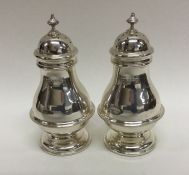 A pair of baluster shaped silver peppers. Birmingh