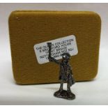 A novelty miniature silver figure of a paper selle