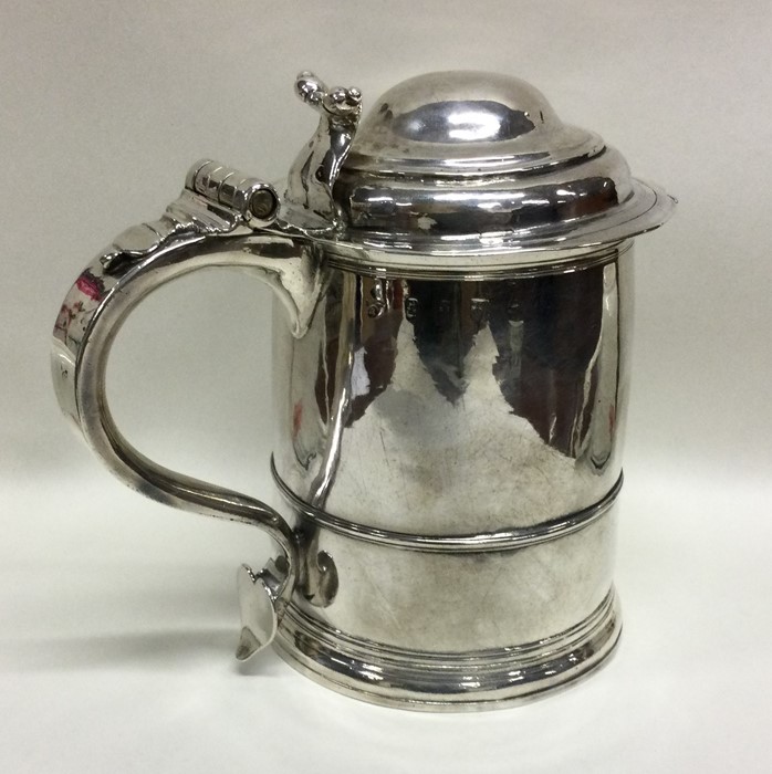 A rare Queen Anne silver lidded tankard with scrol