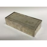 An unusual rectangular silver musical box with bri