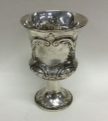 An embossed silver goblet decorated with flowers a