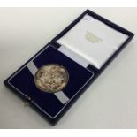 An Edwardian cased silver medallion. Approx. 37 gr