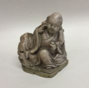 A heavy hardstone figure of a Buddha. Signed to ba