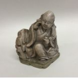 A heavy hardstone figure of a Buddha. Signed to ba