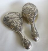 A heavy silver mirror in the form of a stylised la