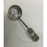 A Chinese silver sifter spoon with aesthetic decor