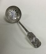 A Chinese silver sifter spoon with aesthetic decor