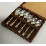 A cased set of six silver engine turned teaspoons.