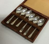 A cased set of six silver engine turned teaspoons.