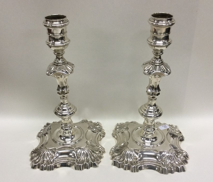 A good pair of Georgian cast silver candlesticks o