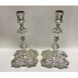 A good pair of Georgian cast silver candlesticks o