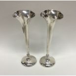 A heavy pair of silver spill vases with shaped bea