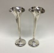 A heavy pair of silver spill vases with shaped bea