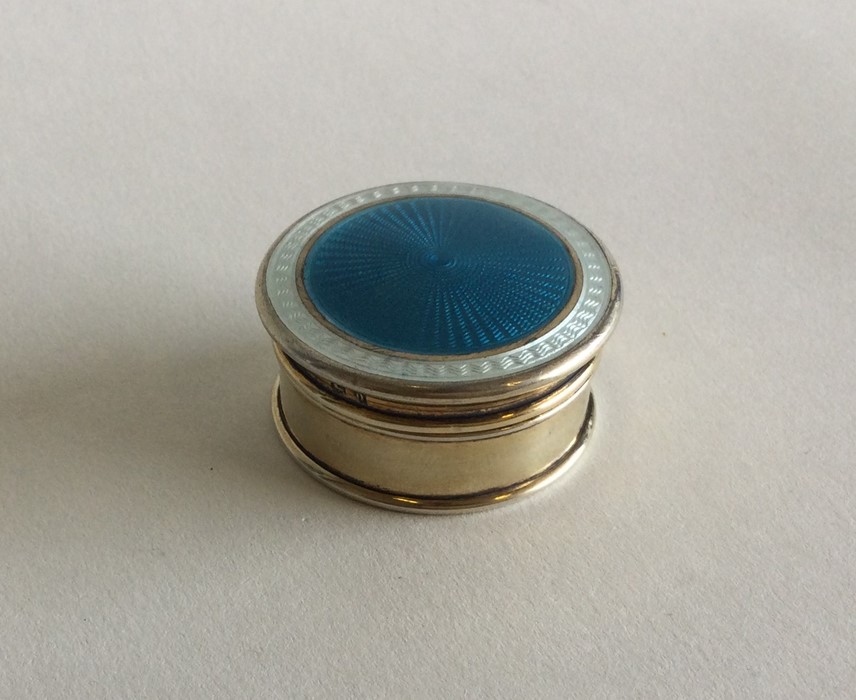 A stylish silver gilt and enamelled box with lift-