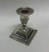 An Edwardian silver candlestick on spreading foot.