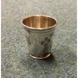 An engraved silver beaker of tapering form decorat