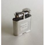 A solid silver Dunhill lighter with engine turned