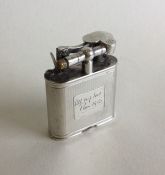 A solid silver Dunhill lighter with engine turned