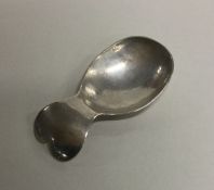 A stylish silver caddy spoon of heart shaped desig