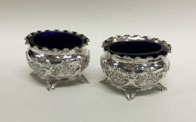 A pair of heavy Edwardian silver salts decorated w