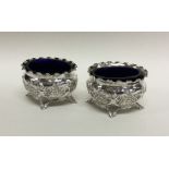 A pair of heavy Edwardian silver salts decorated w