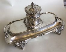 A good quality silver inkstand decorated with scro