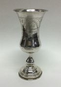 A large silver goblet decorated with flowers and l