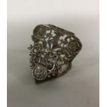 A heavy silver heart shaped clip embossed with flo