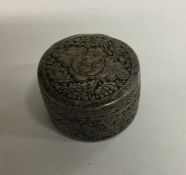 A Chinese circular silver box decorated with drago
