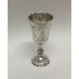 A stylish silver goblet with engraved decoration.