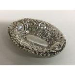 An attractive oval silver bonbon dish decorated wi