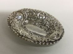 An attractive oval silver bonbon dish decorated wi